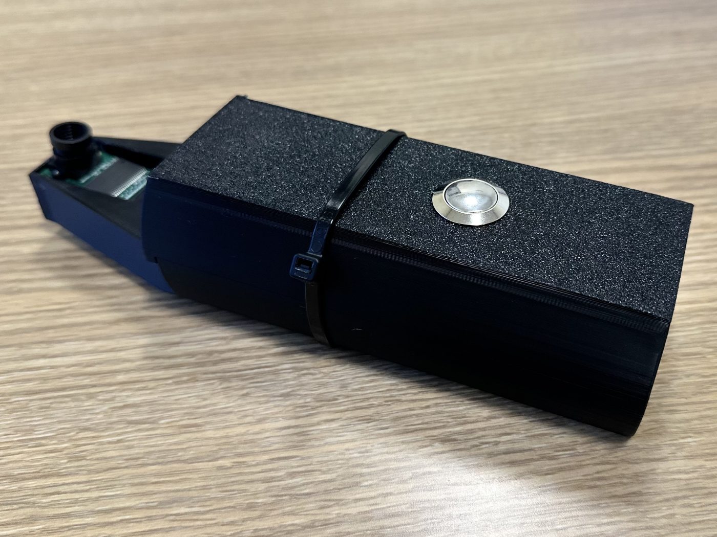The assembled OralVision V1 prototype, a black 3D-printed handheld with a metal capture button and a camera at the tip.