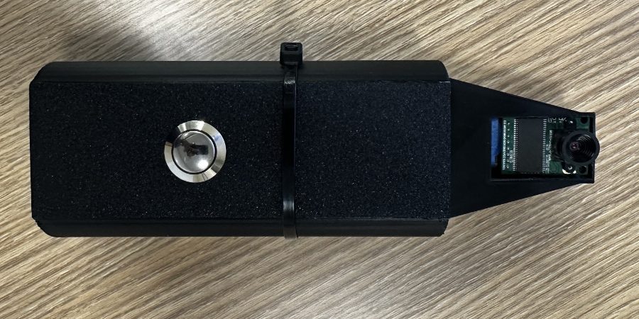 Top-down view of the assembled prototype, showing the medical-grade capture button on the body and the OV5642 camera board seated in the tapered nose.